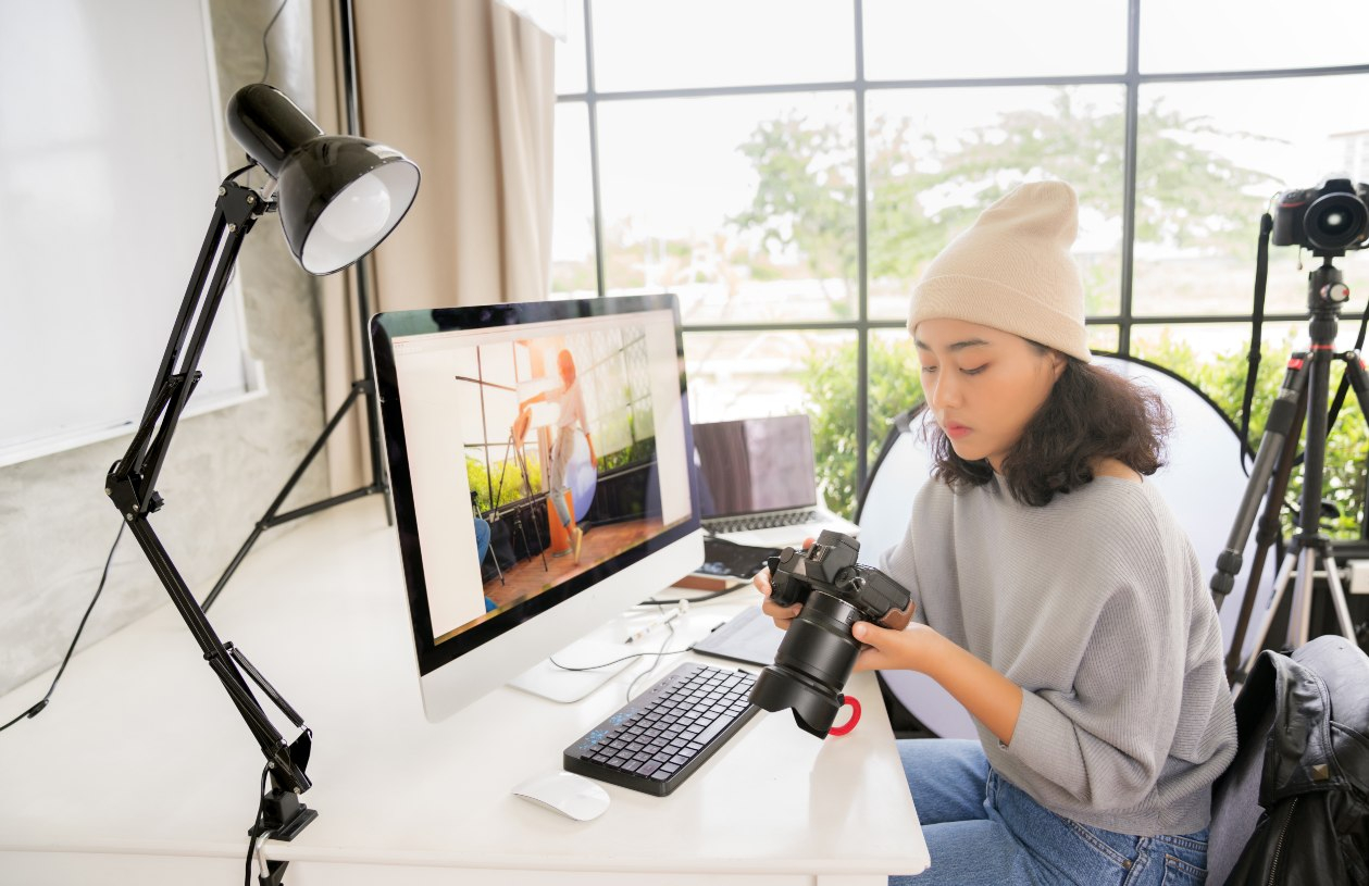 Teenager looking at her camera at her workstation in a home