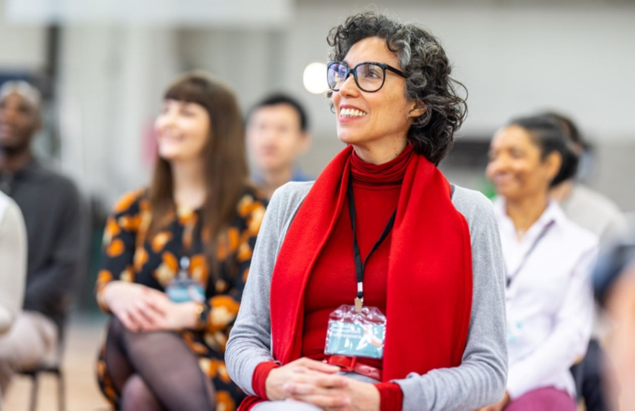 Woman happily attends class for professional certification and personal development.