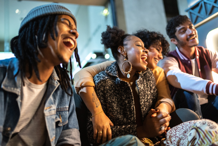 Group of millennials having fun at night outdoors