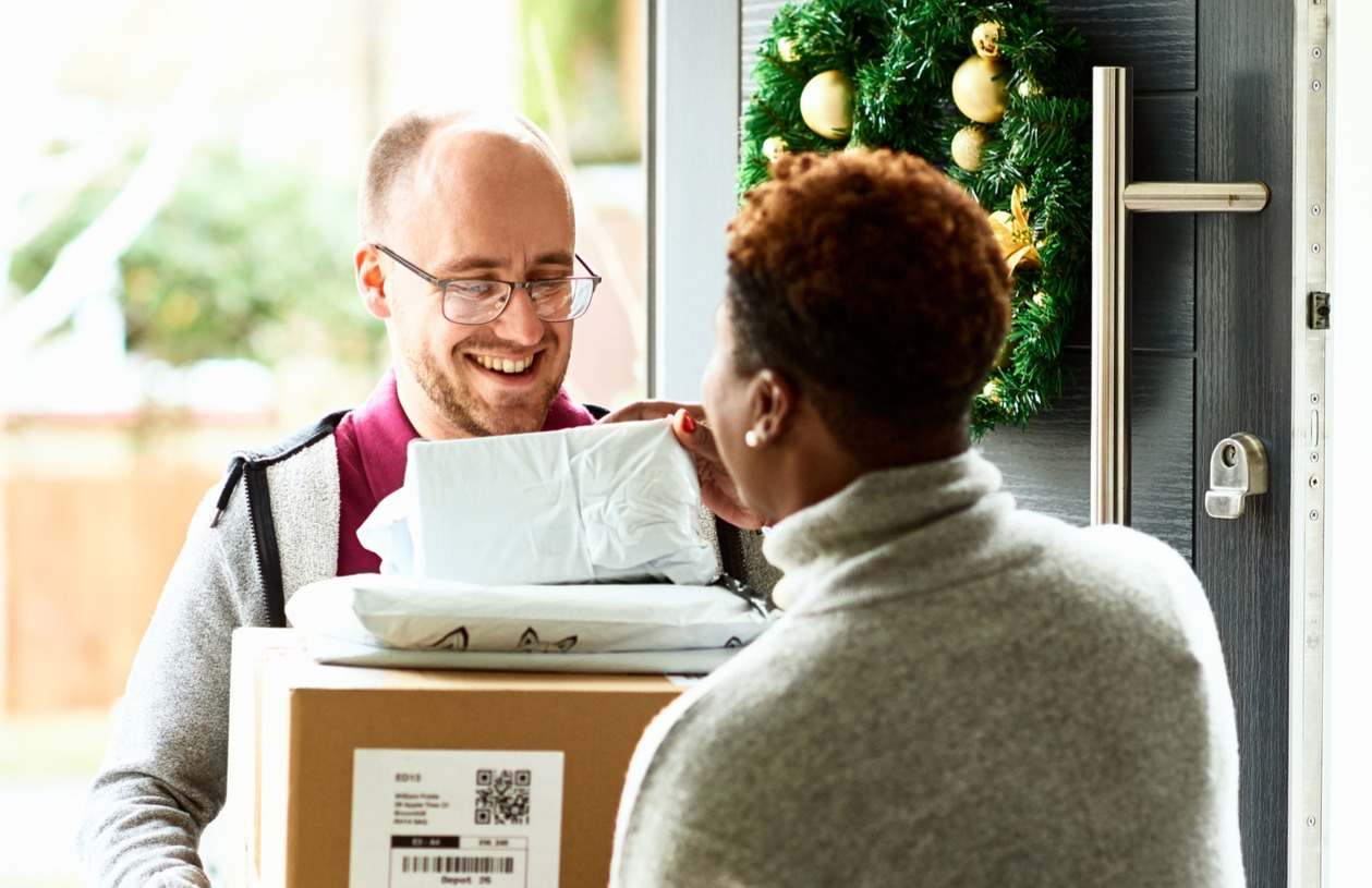 Woman tips delivery man during the holidays.