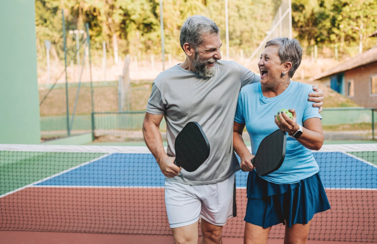 A retired couple playing pickleball