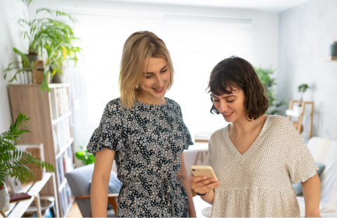 Two twenty-something women check for junk fees before checking into a short-term rental.