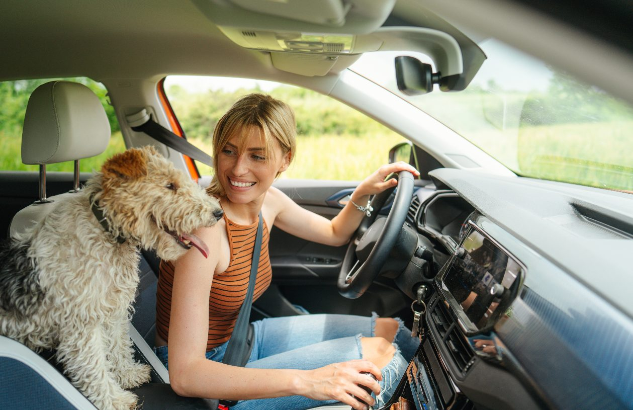 Girl in car with dog