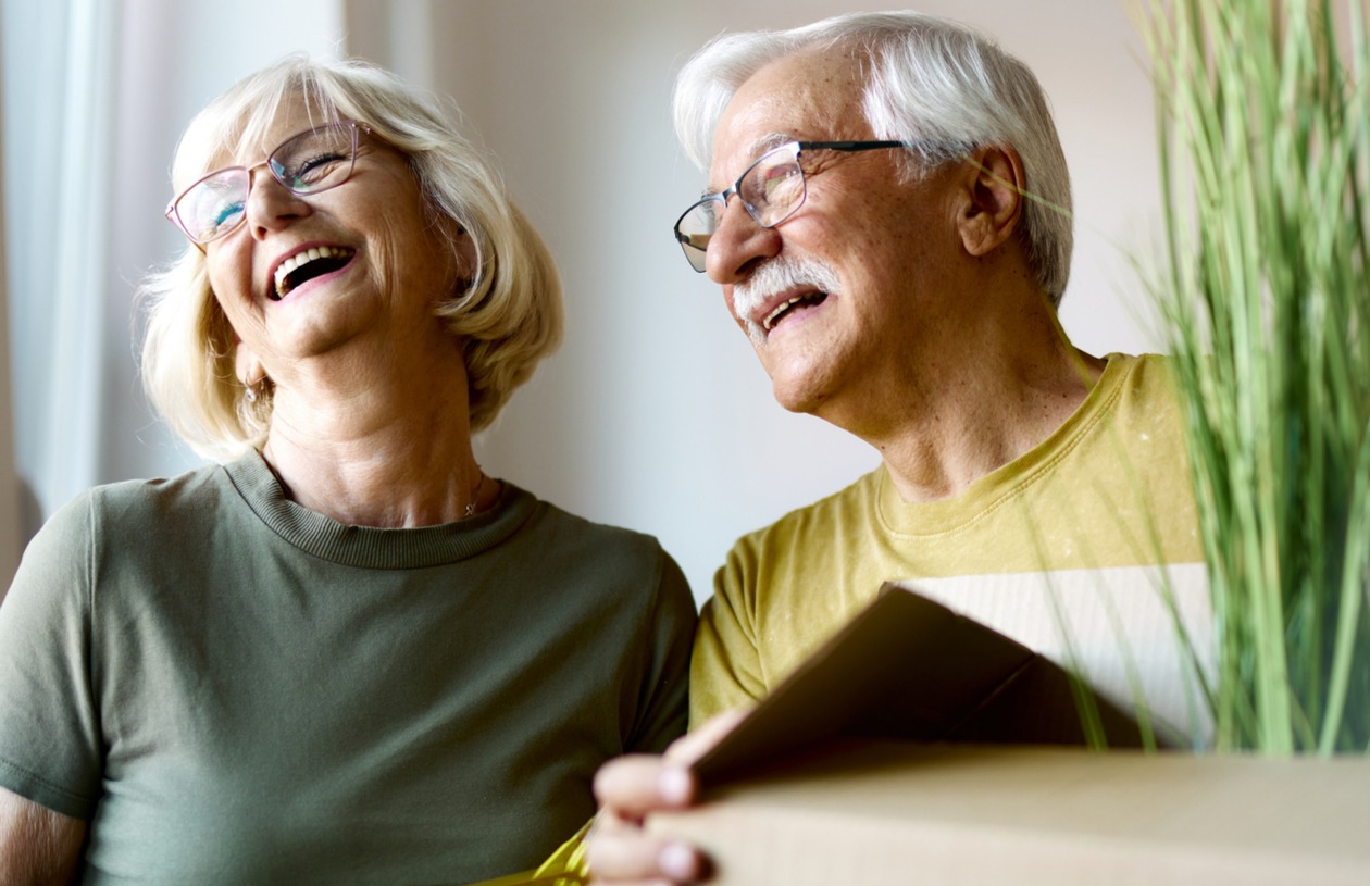 Couple happily moves boxes made possible by a home equity line of credit being part of their long-term financial strategy