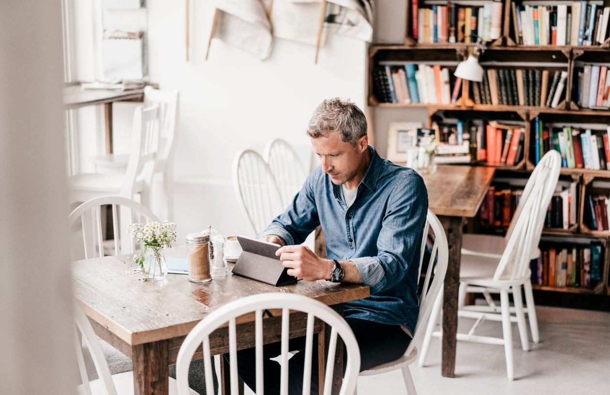 Man reading about how to avoid bank fees