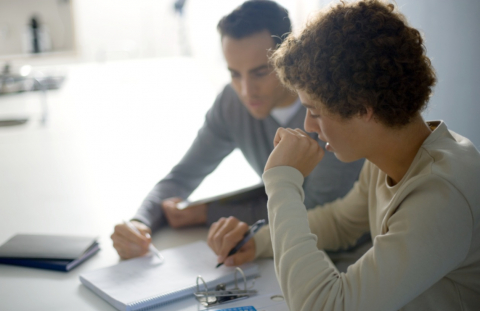 Dad and son work on finances together 