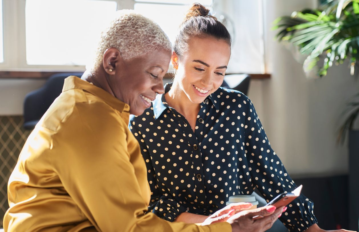 grandmother and granddaughter using device