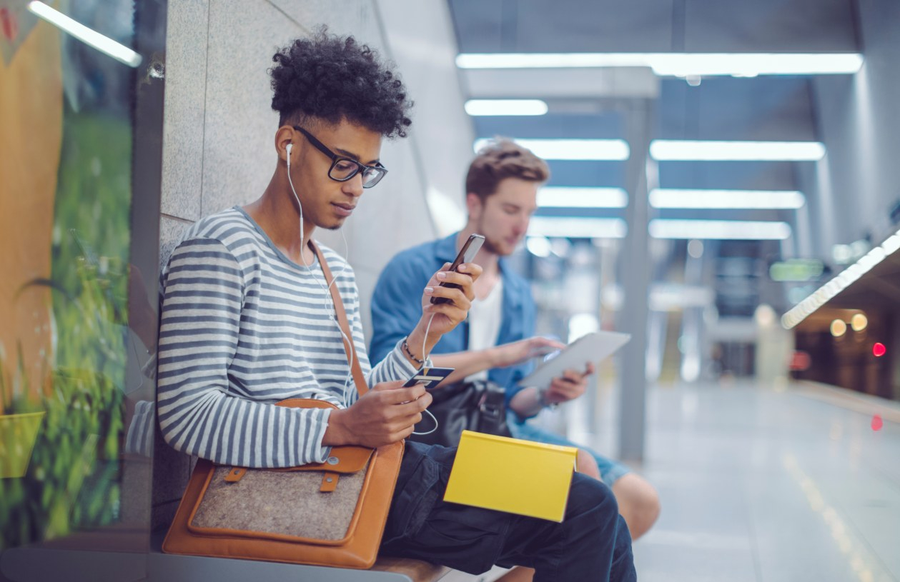 A man uses his credit card during his commute.