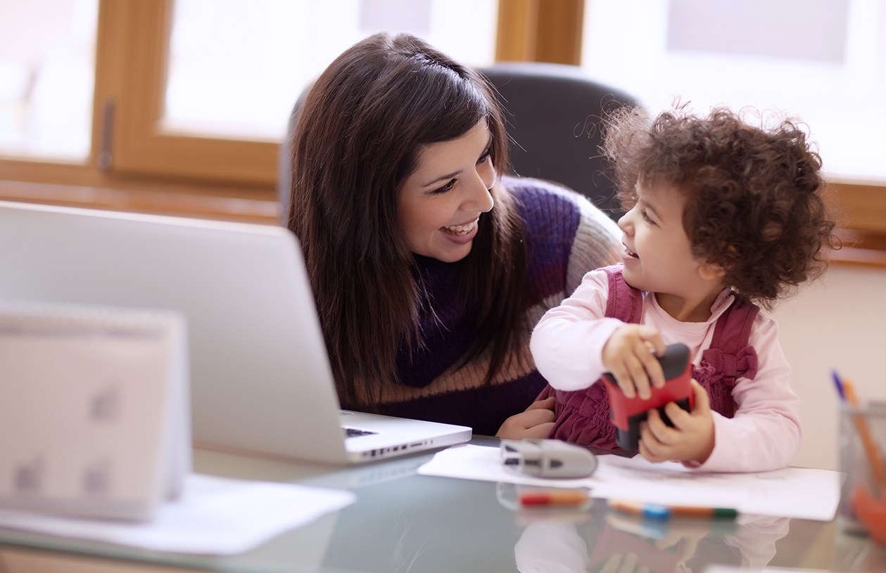 A stay-at-home mom working from home with her baby vs. going to daycare.
