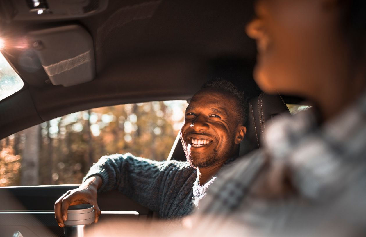 Man smiles after finding the Best Ways to Get a Low Interest Auto Loan