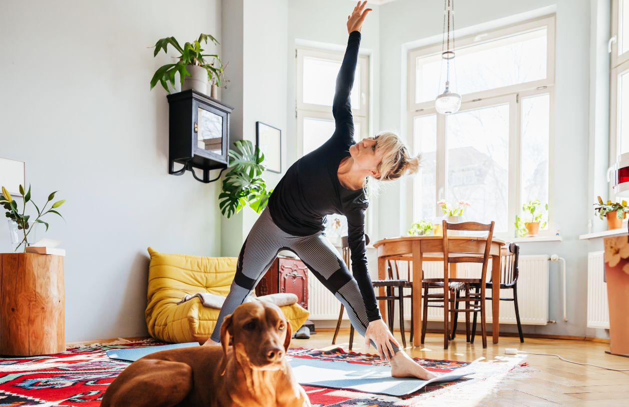 After getting a heloc, a woman practices yoga in her home.