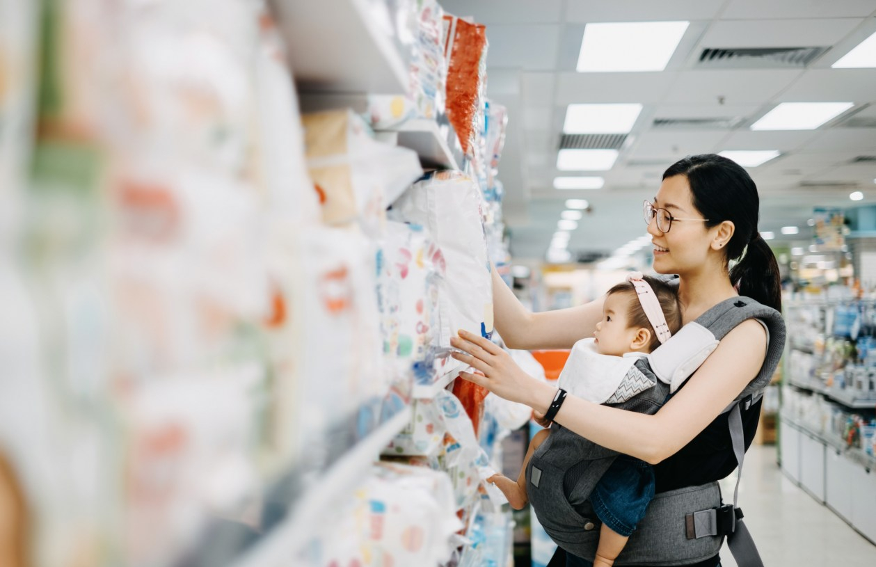 Woman shops for sale price on diapers.