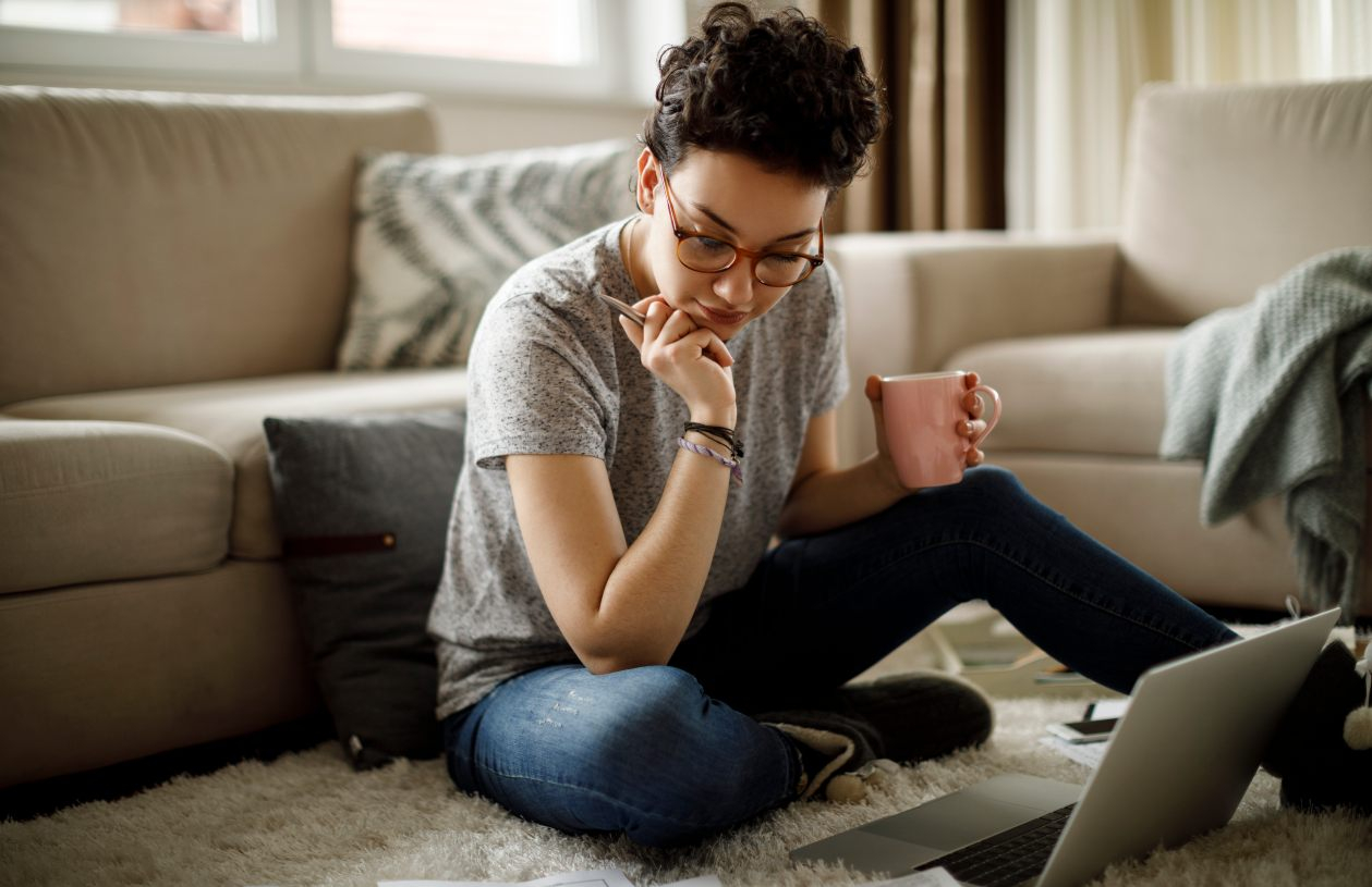 A woman researches How much money should I keep in my savings account?