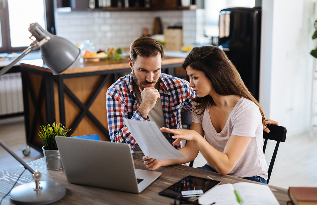 couple reviewing credit card statement after prime rate change